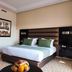 Hotel Andalucia Golf & Spa Tanger room in Tangier with king bed and patterned carpet