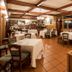 Lokanda Devetak dining room in Capriva del Friuli with wooden beams, tiled floor, and set tables