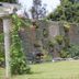 The Q Hotel Tagaytay garden with stone wall, lush greenery, and lawn