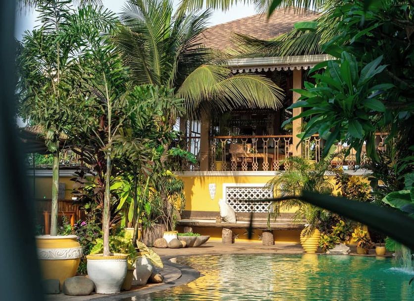 Fiesta Beach Resort in Baga with tropical garden and outdoor pool beside a villa