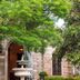 Elizabethan Lodge in Blackburn: stone entrance framed by lush trees and a decorative fountain