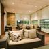 Lounge seating area at Protea Hotel by Marriott Bloemfontein with large windows and wood flooring