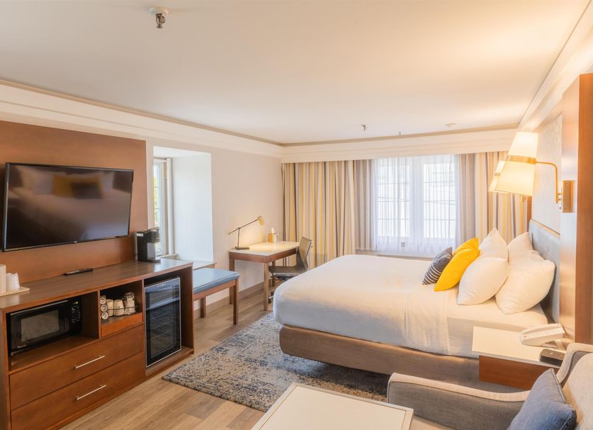 The Westfield Inn, BW Signature Collection guest room with king bed, desk and TV in Westfield
