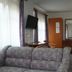 Hotel Am Markt in Eckartsberga guest room with sofa, TV, bed, and mirror