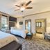 The Beaufort Inn in Beaufort guest room with two beds, ceiling fan, floor lamp, and patterned carpet