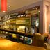 Premier Inn Ashford - Eureka Leisure Park bar with beer taps, backlit bottles and curved wooden counter in Ashford