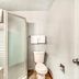 OYO Hotel Houston Southwest I-69 bathroom with shower stall, toilet, and sink in Houston