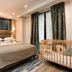 Serotel Suites Paris guest room with king bed, crib, desk and large windows
