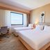 Park Dedeman Denizli guest room with two beds, desk, and large window view in Denizli