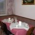 Pension Berggeist in Sölden dining nook with set table, pink tablecloth, cups and window seat