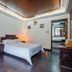 Changle Inn in Yangzhou guest room with bed, dark wood floor, and adjoining bathroom