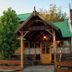 Hostal de la Laguna in Ushuaia with rustic wooden exterior and green metal roofs