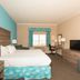 Amelia Hotel at the Beach guest room with king bed, desk, TV and window view in Fernandina Beach