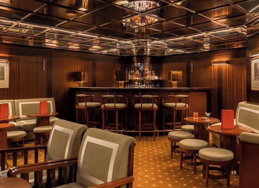 Hôtel Des Grands Voyageurs bar lounge in Paris with mirrored ceiling and seating