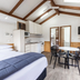 Nrma Ballarat Holiday Park studio room with bed, kitchenette, dining table and TV in Ballarat