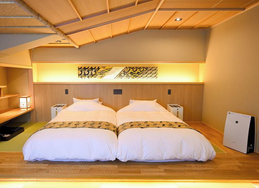 Matsubaya Ryokan in Kyoto twin beds on tatami platform with warm lighting and low Japanese-style ceiling