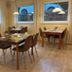 Arador City Hotel in Bad Oeynhausen dining room with wooden tables, chairs, and pendant lights