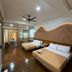 Anjung Pantai Seberang, Kuala Terengganu: twin beds in a wood-floored hotel room with ceiling fan