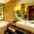 The Longemont Shenyang bathroom with soaking tub, vanity sink and view into the bedroom