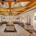 Club Mahindra Emerald Palms, Goa in Varca: bright restaurant with buffet island, patterned aisle and wood-beam ceiling