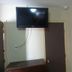 Star Inn Karnes City room with wall-mounted TV, door, and dresser