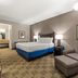 Americas Best Value Inn Byhalia guest room with king bed and sitting area