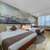 East Garden Hotel Chongqing guest room with two beds, city mural, and window seating