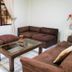 Hotel Armonía Hostal in San Salvador: simple lounge with brown sofas and glass coffee table