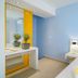 Thassos Olivia Resort in Potos guest room with twin beds, blue walls, and vanity mirror