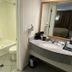 Quality Inn Branson - Hwy 76 Central bathroom with shower-tub combo, toilet, and granite vanity