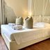Soggiorno Pezzati Florence guest room with king bed, bedside lamp, and wooden floor