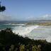 Hotel La Costera in A Lanzada with ocean waves breaking along a sandy bay