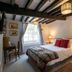 The Old Vicarage Hotel & Restaurant in Bridgwater: cozy guest room with exposed beams, double bed and window view