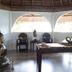 Iris Island Eco Resort in Busuanga spa room with massage table, Buddha statue, and arched windows