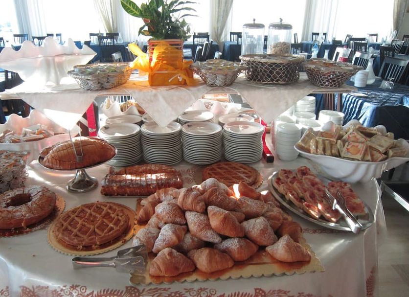 Hotel San Francisco Spiaggia in Rimini buffet table with pastries, croissants, waffles and bread rolls