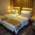 Orchardz Hotel Industri Jakarta twin room with two single beds and bedside lamps
