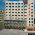 OYO Hexi Hotel in Zhangye, exterior view of a multi-story hotel building with adjacent storefronts