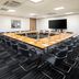 Holiday Inn London - Gatwick Airport By IHG meeting room with conference table, chairs and wall-mounted screen