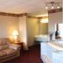 Regency Inn Richmond room with sofa, lamp, sink vanity and bathroom area in Richmond