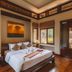 Khaolak Bhandari Resort & Spa room in Khao Lak with king bed, wood floors and garden-view windows