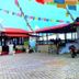 Stupa Resort in Nagarkot with a paved courtyard, red-roofed buildings, and colorful prayer flags
