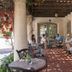 Brisas Del Mar Inn at the Beach in Santa Barbara courtyard seating under a pergola with garden vines