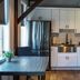 Old Mill Inn Hatfield kitchen with stainless steel appliances, white cabinets and dining table