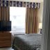 Arya Blu Inn and Suites in Ormond Beach room with king bed, TV, and window air conditioner