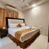 Housez 43 Kolkata bedroom with tufted bed, air conditioner, and vanity