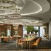 Rosewood Guangzhou dining room with circular chandeliers, long tables, and floor-to-ceiling city views in Guangzhou