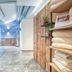 Hotel Leipziger Hof, Innsbruck: bright spa corridor with wood-paneled walls, marble floor and folded towels