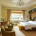 Danesfield House Hotel And Spa bedroom in Marlow with four-poster bed, fireplace, and bay-window seating