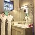 Dar Charkia Marrakech bathroom with twin robes, vanity sink, mosaic mirror and window