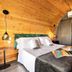 I Capricci Di Merion - Resort & Spa room in Tuoro sul Trasimeno with wood-paneled walls and double bed